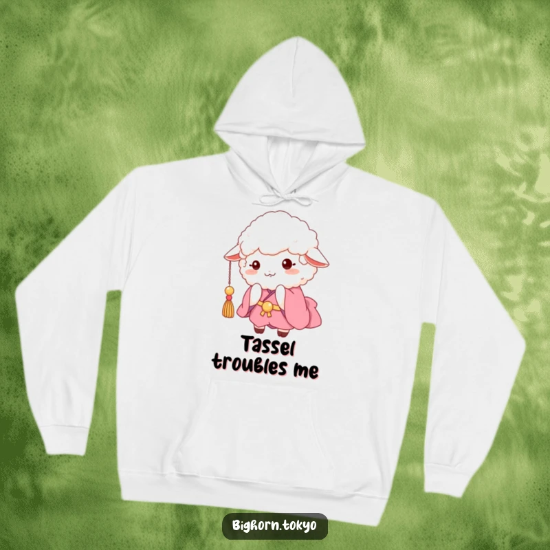 Funny fluffy sheep in a pink kimono batting at a tassel, a cozy and humorous hoodie for playful comfort.